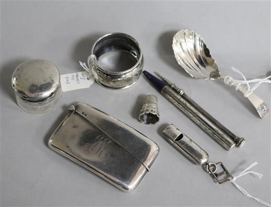Eight assorted small silver items including a Georgian Scottish caddy spoon, a card case and whistle.